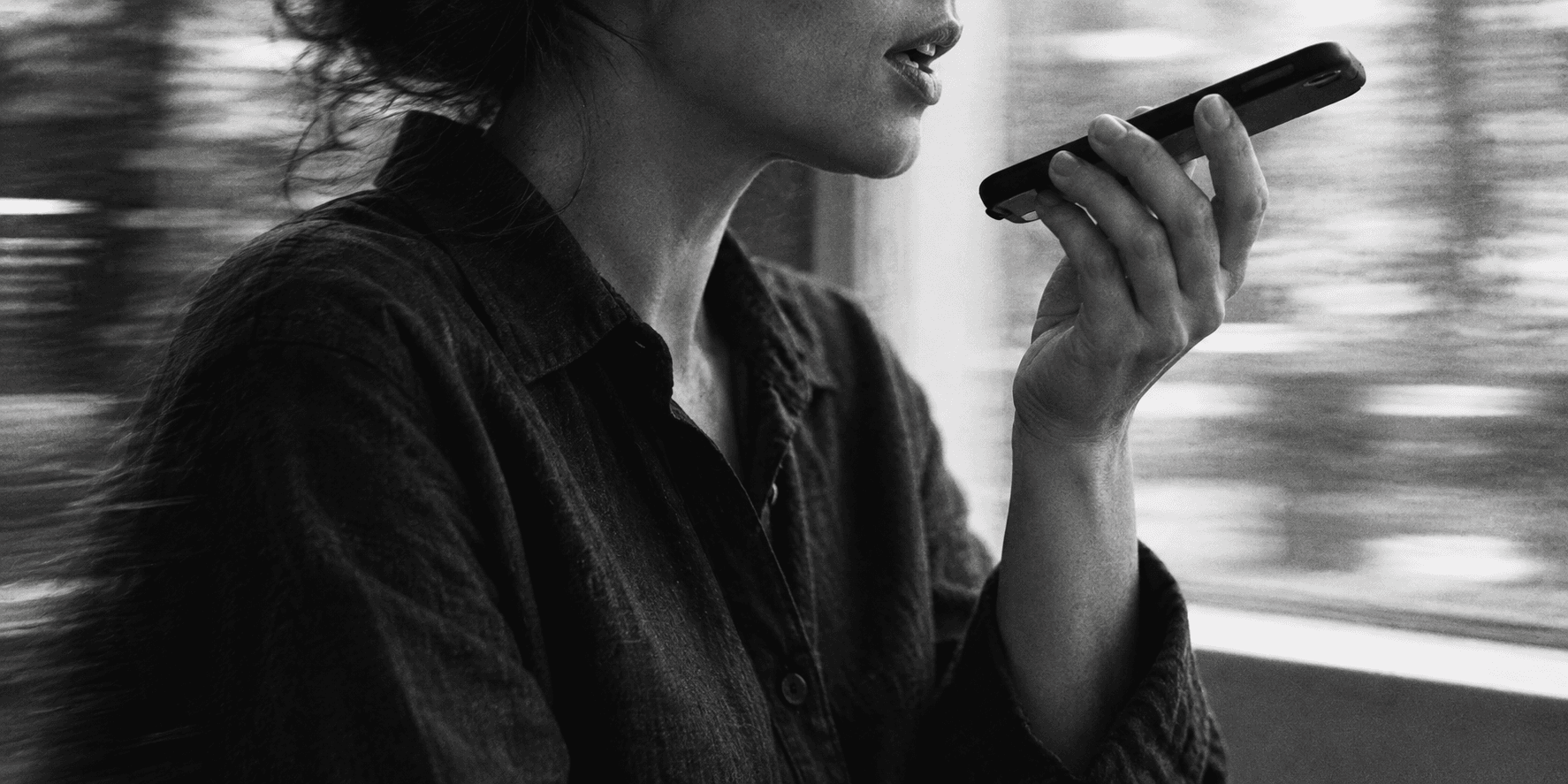 Editorial image of a person recording a voice note on a phone